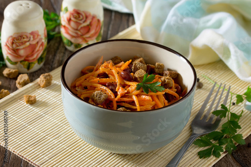 Salad of carrots in Korean with red beans, garlic and croutons o