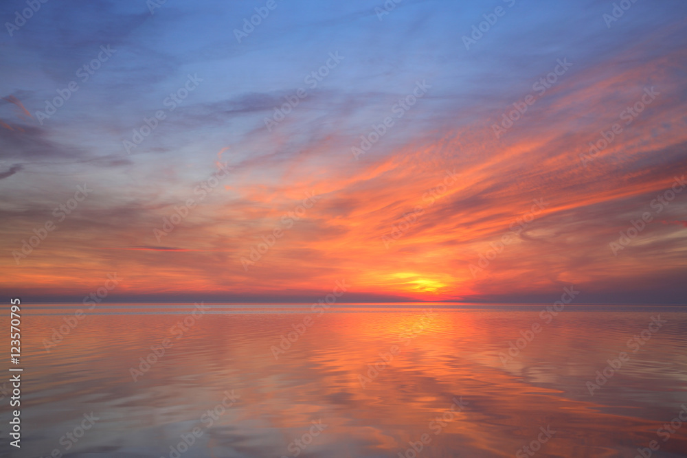 Coastal Sunset, Red Clouds reflecting in Calm Sea