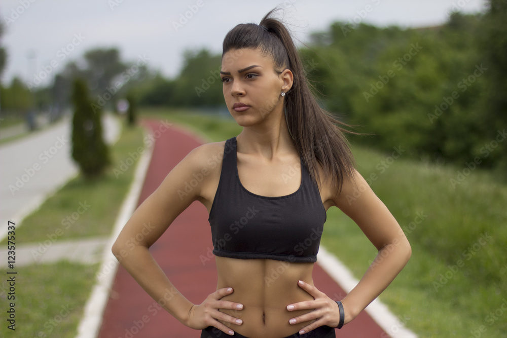 Fitness girl on tartan track