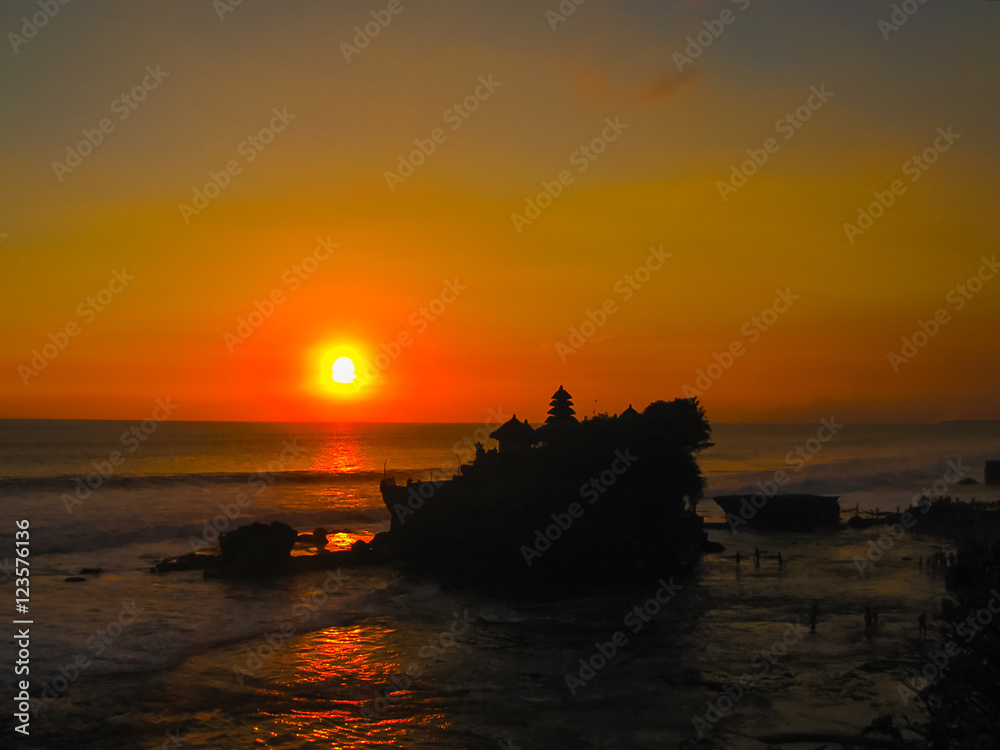 Tanah Lot and sea waves in golden sunset, Bali