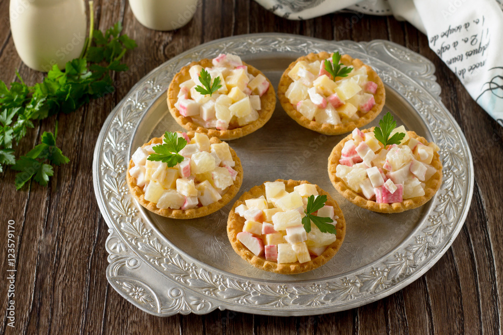 Holiday appetizer: tartlets with crab sticks, cheese and pineapp