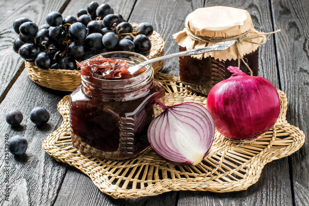 Onion jam with grapes in glass jars