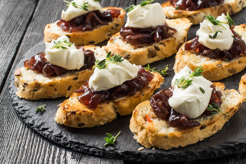 Canape with onion jam, cream cheese and thyme