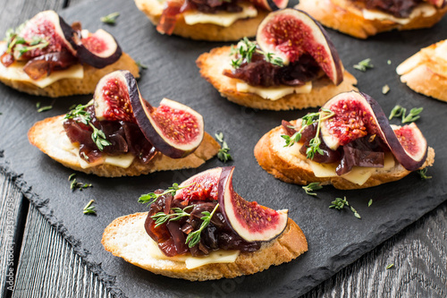 Canape with cheese, onion jam, figs and thyme