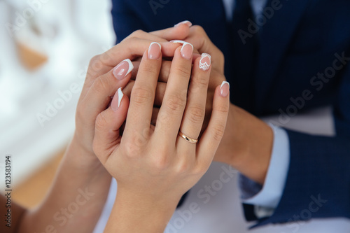 Bride and groom's hands with wedding rings