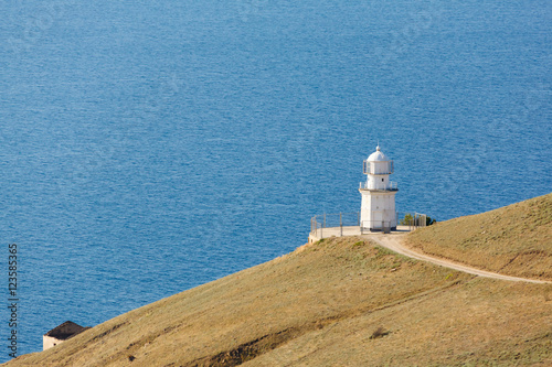 white lighthouse on the background of the sea