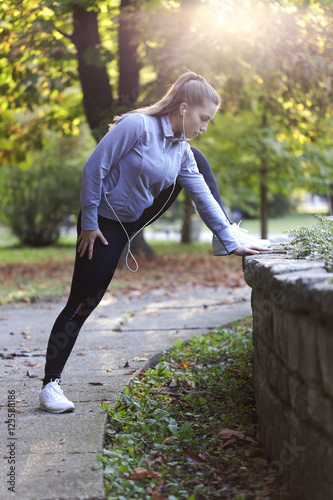 Young women stretching before running