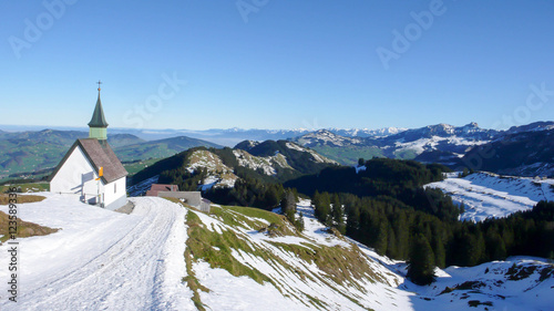 small white chapel in the mountains of the Swiss Alps