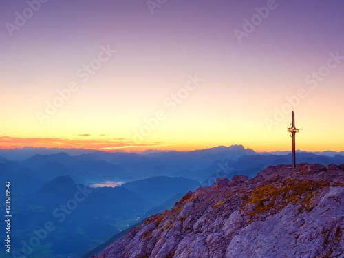 Peak of Hoher Göll. Iron cross at mountain top in Alp at Austria Germany border.
