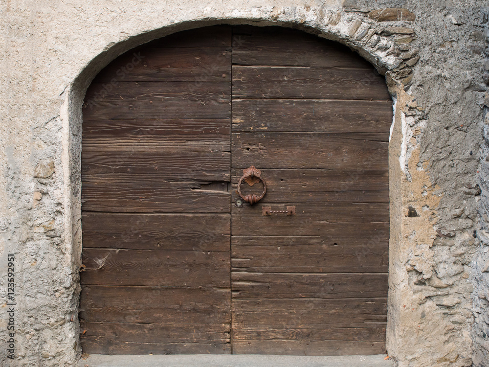 Old Wooden door with handle knocker and lock of medieval house Old Wooden door with handle knocker and lock of medieval house