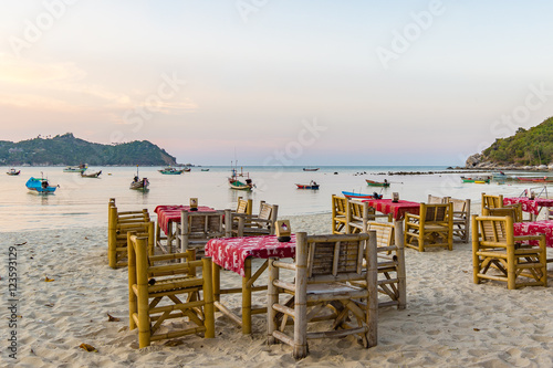 Restaurant tables on a tropical beach