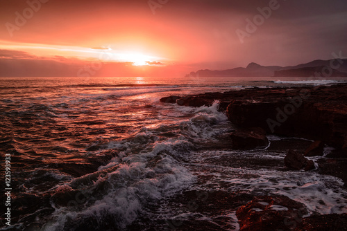 Storm sea at sunset on the south coast