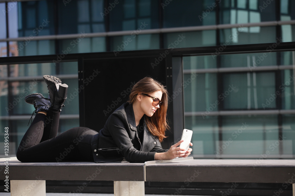 Fototapeta premium Young beautiful woman taking a selfie in the city