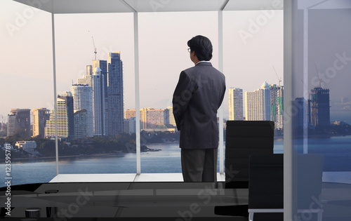 Businessman looking at city through window looking forward in the future for making ideas concept or decision some things , use for advertising or business ideas