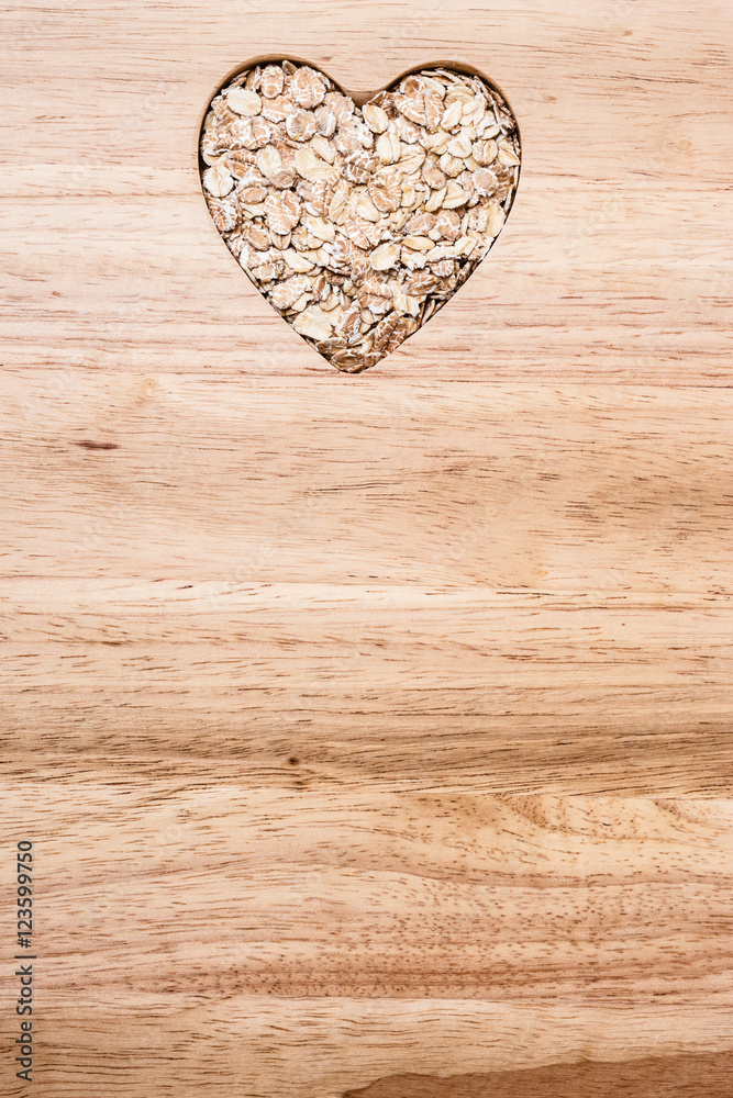 Oat cereal heart shaped on wooden surface. Oat cereal heart shaped on wooden surface.