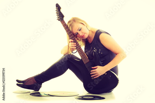 Woman with electrical guitar and vinyl record.