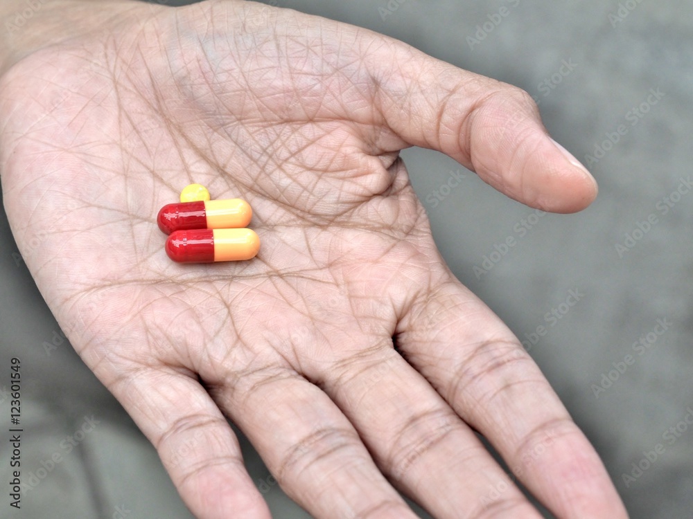 elder hand holding or offering pills, concept of healthy and medical. elder hand holding or offering pills, concept of healthy and medical.