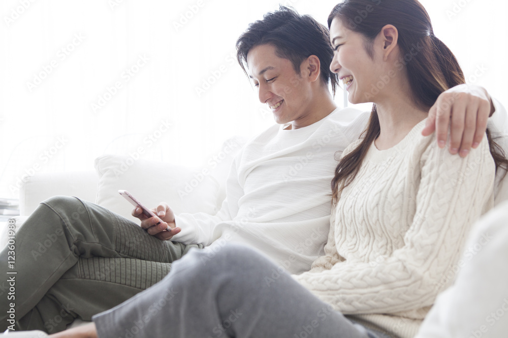 The couple are sitting with his shoulders on the sofa The couple are sitting with his shoulders on the sofa