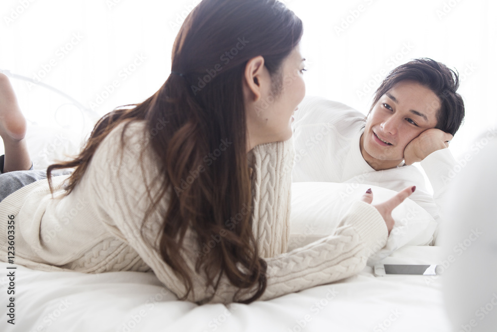 Men and women are talking happily in on the bed