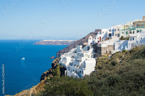 Seacoast and white Oia town on mountain