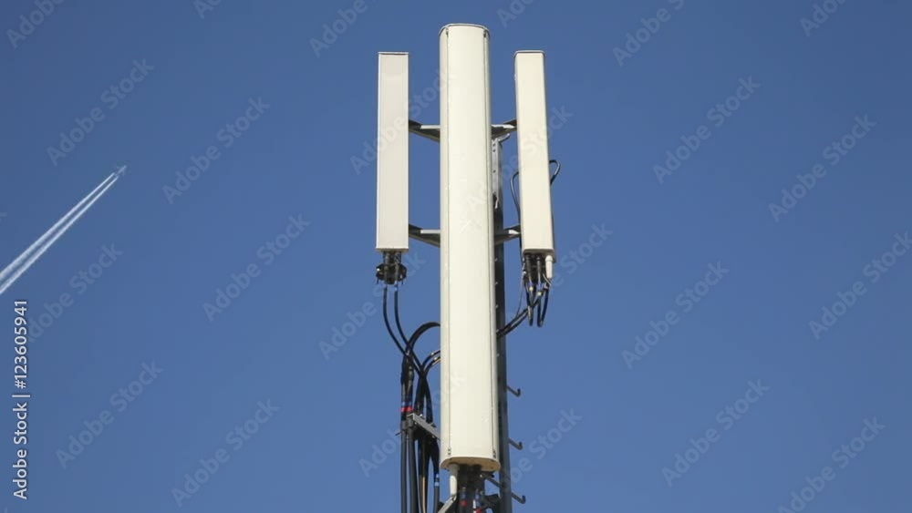 Antenna mobile transmitter tower with an airplane flying at background. Close up. Antenna mobile transmitter tower with an airplane flying at background. Close up.