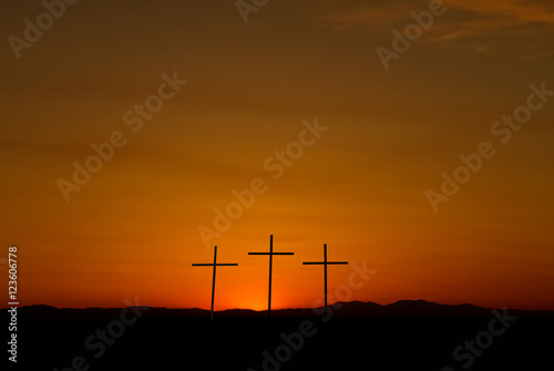 Three crosses on a hill over bright sunset with copy space © mbolina
