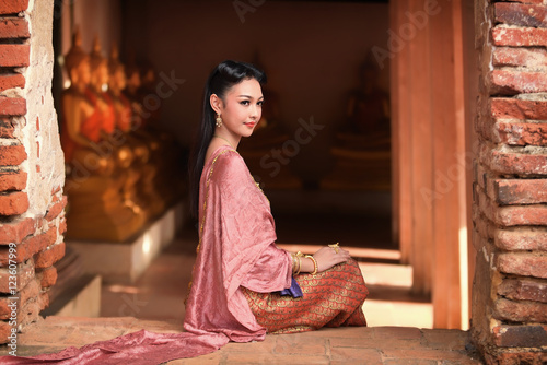Women in Thai dress at the old temple. Noppamas Queen Contest in Loy kratong tradition.

