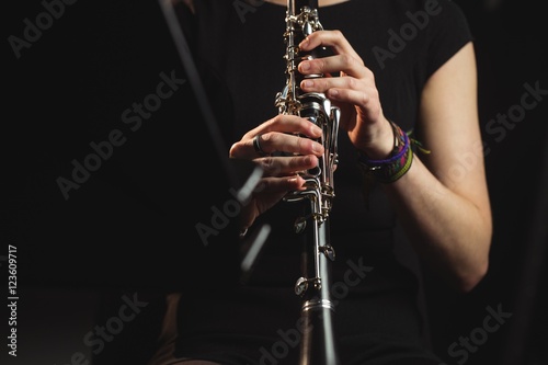 Woman playing a clarinet in music school