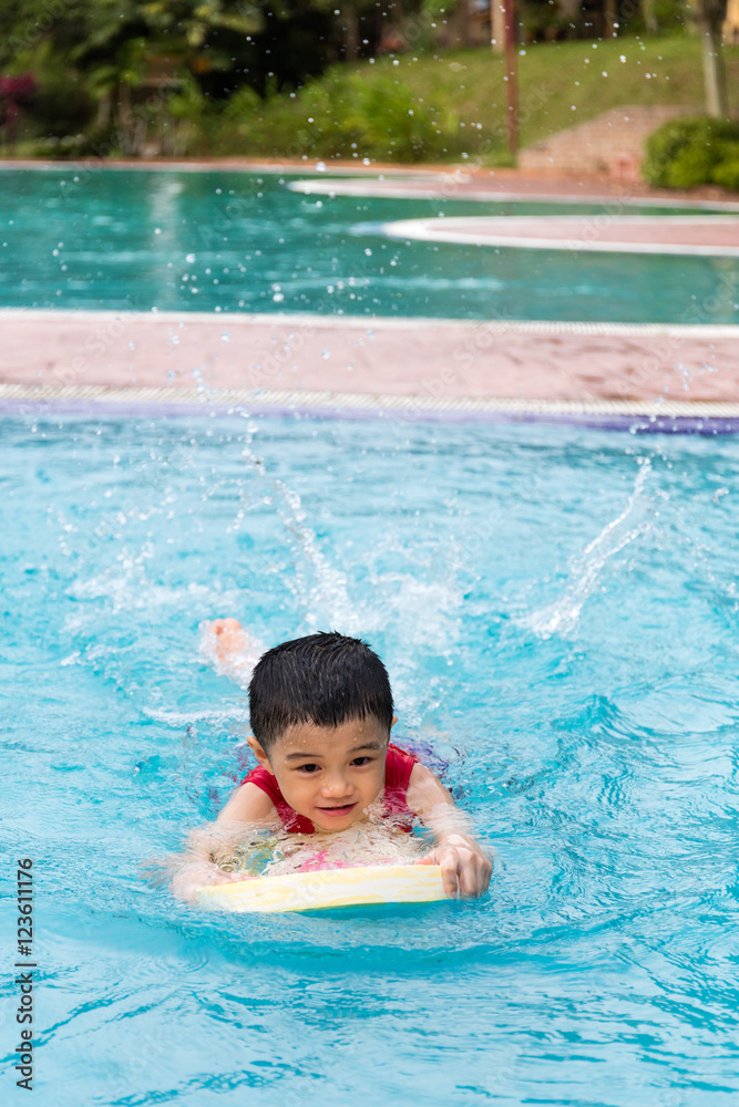 Asian Chinese Little Boy Swimming With Floating Board