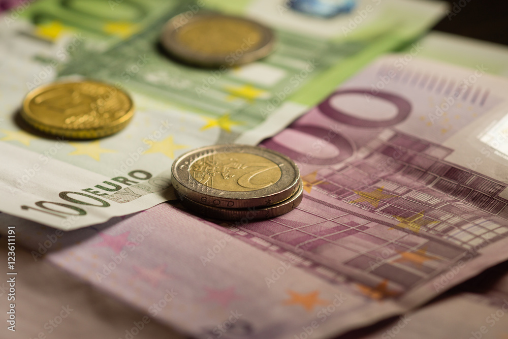 Euro coins and banknotes money. Macro background.
Euro coins and banknotes money. Macro background.