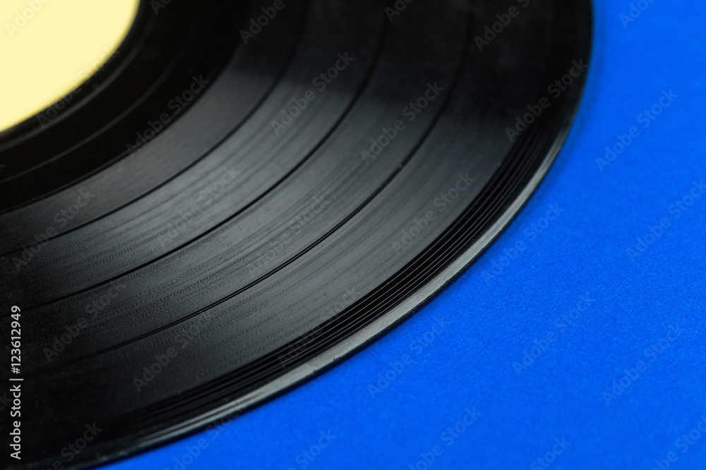 Retro vinyl record on blue background Retro vinyl record on blue background