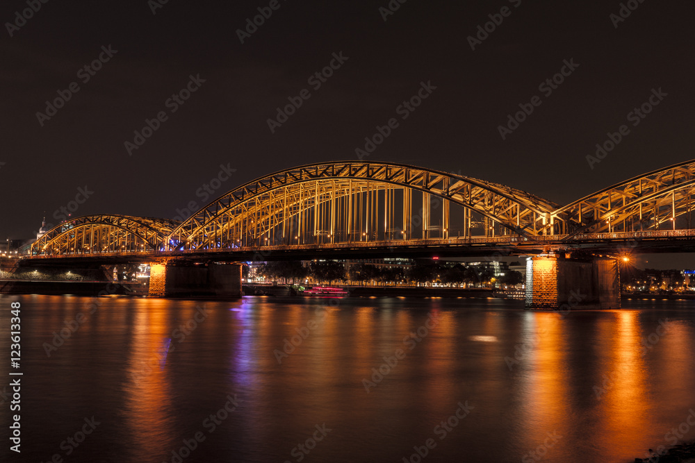 Illuminated bridge in Cologne at night