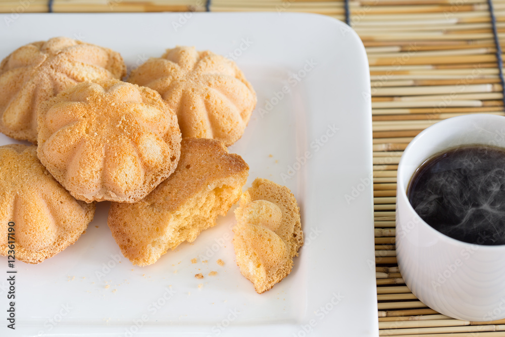 Egg cake, delicious dessert and black coffee in white dish on ba Egg cake, delicious dessert and black coffee in white dish on ba