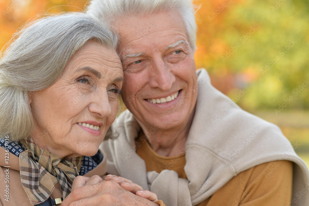 Portrait of a beautiful middle-aged couple in the autumn park Portrait of a beautiful middle-aged couple in the autumn park