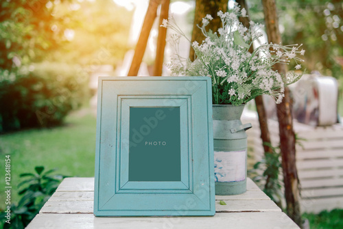 vintage blank frame with flowerpot on table in wedding day