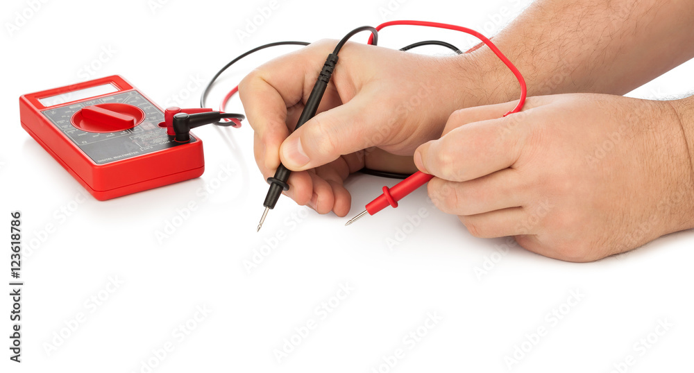 Hands and electric multimeter