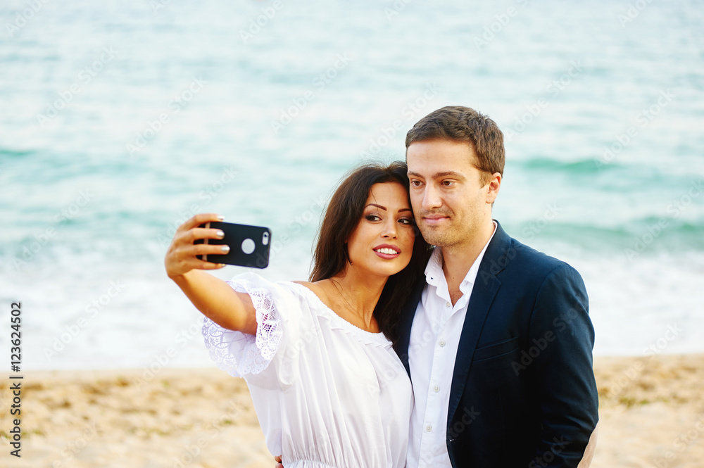 young couple makes a selfie in the background of the sea . Photo for memory
