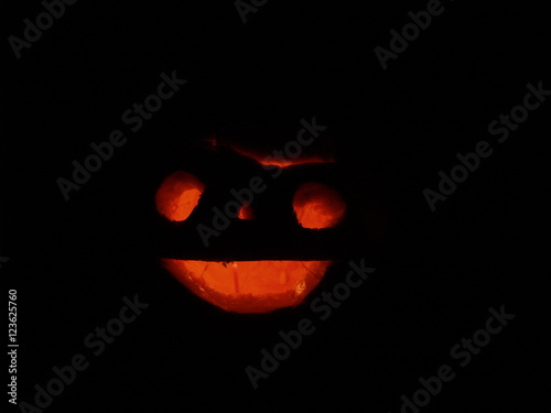Scary Halloween pumpkins isolated on a black background.  glowing faces trick or treat