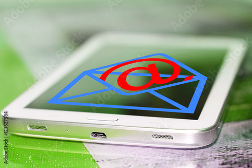 Email symbol on screen of cell phone . The concept of online correspondence .