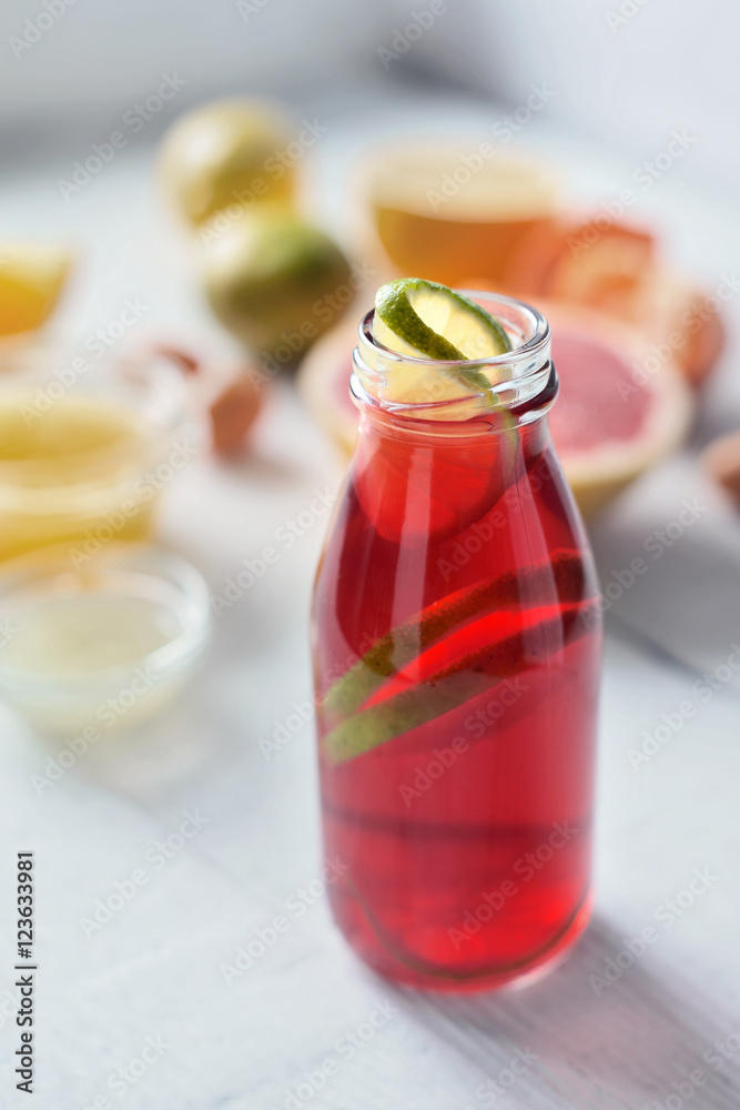 Citrus juice on the white wooden table vertical