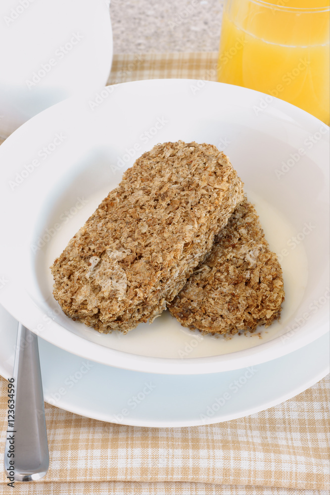 Whole wheat breakfast cereal served with milk