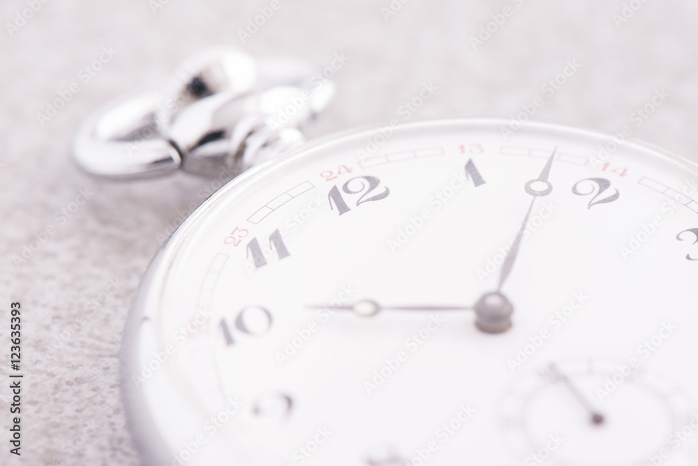 Pocket watch in close up lying on stone table. Vintage timepiece still life. Concept of time, deadline and nostalgia. Pocket watch in close up lying on stone table. Vintage timepiece still life. Concept of time, deadline and nostalgia.
