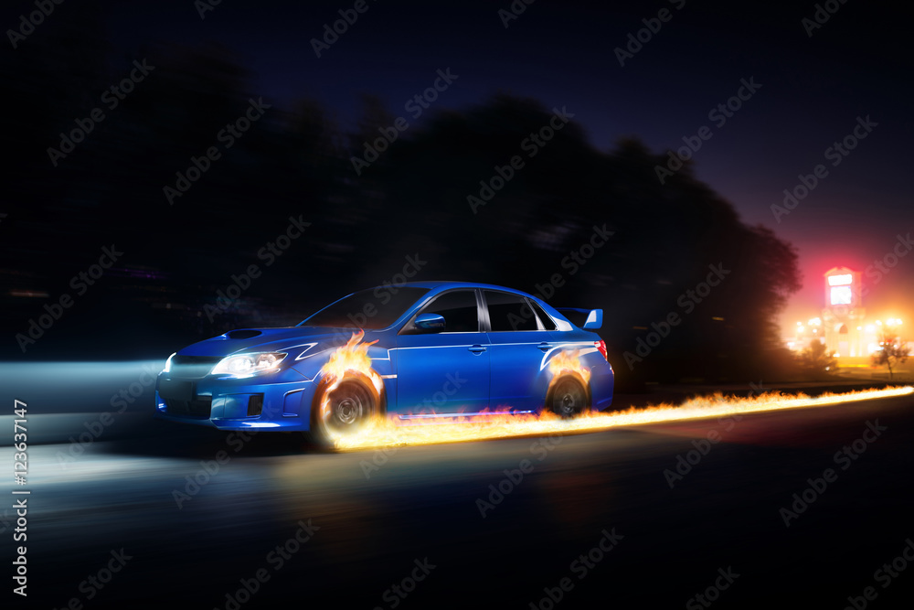 Fototapeta premium Blue car drive on asphalt countryside road with fire wheels at night