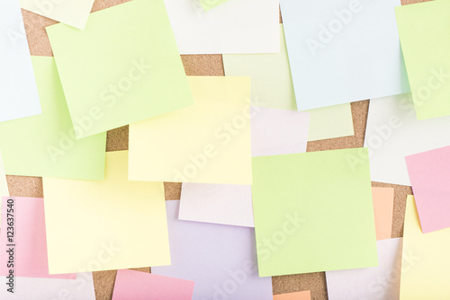 Empty blank sticky notes on notice board in office. Background or backdrop for business information. Concept image of communication or reminder with copy space.