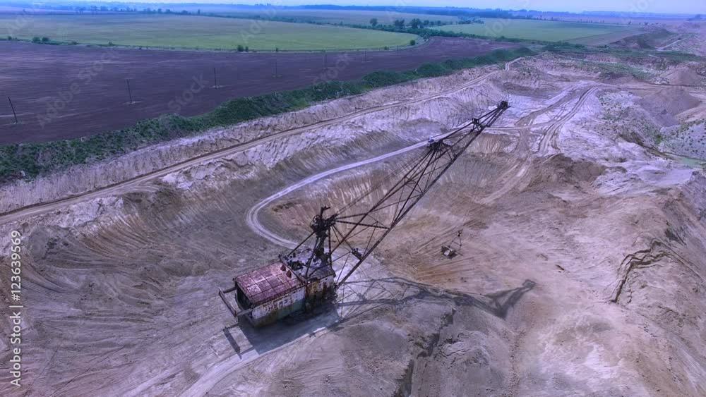 Flying over the excavator in a quarry. Production of manganese ore. aerial survey Flying over the excavator in a quarry. Production of manganese ore. aerial survey