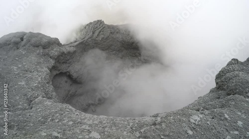 Volcanic activity on Kamchatka Peninsula - view of boiling thermal mud pot in the crater of active Mutnovsky Volcano. Eurasia, Russian Far East, Kamchatka Region.