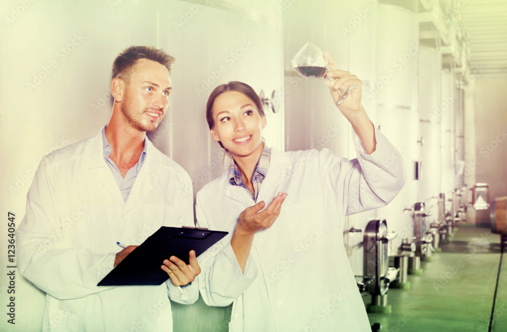 Obraz premium Man and woman employees on winery manufactory