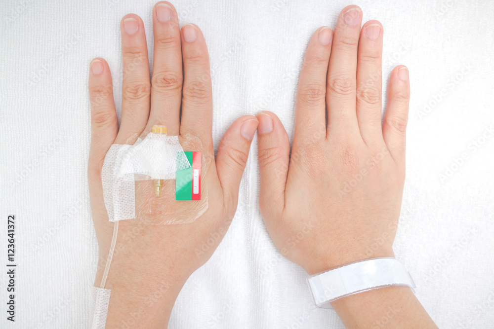 IV solution in a patient hand IV solution in a patient hand