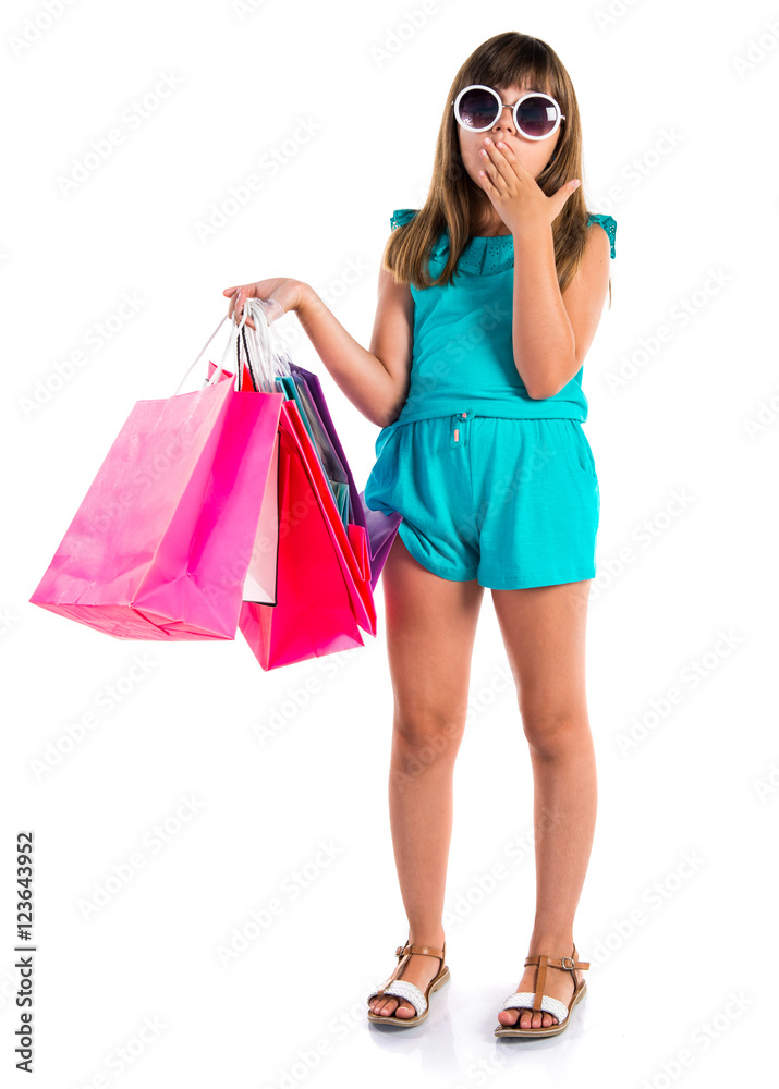 Surprised little cute girl with many shopping bags Surprised little cute girl with many shopping bags