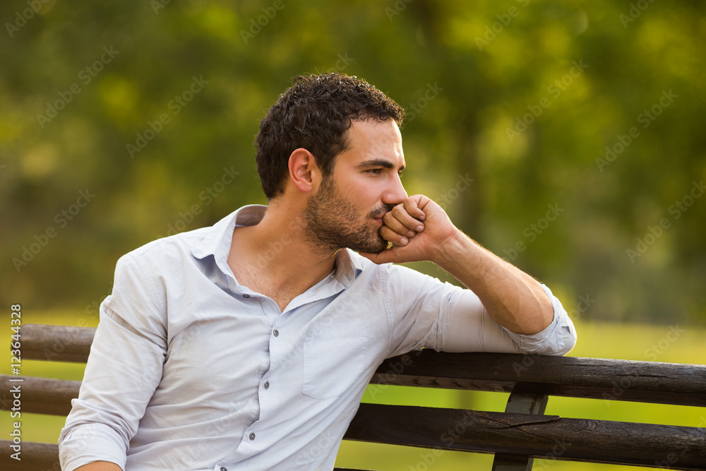 Worried businessman is sitting at the park and thinking about something. Worried businessman is sitting at the park and thinking about something.